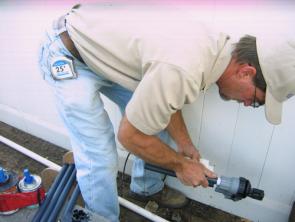 a tech prepares a new pop up head for installation