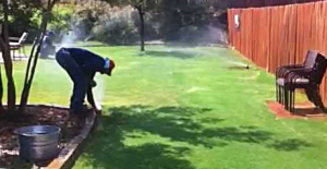 a Little Elm sprinkler repair tech is adjusting a pop-up head